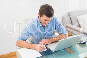 Businessman writing at his desk