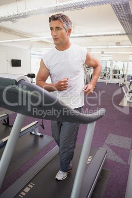 Fit man working out on treadmill