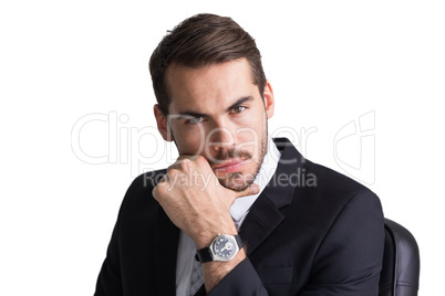 Cheerful businessman posing with hand on chin
