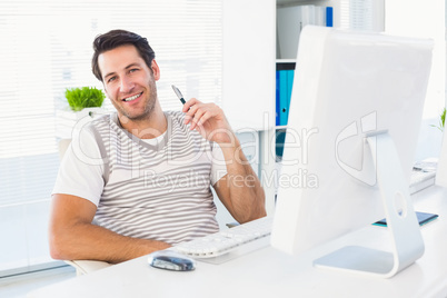 Smiling man with computer in a bright office