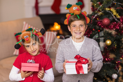 Brother and sister in headband holding gift