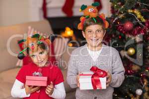 Brother and sister in headband holding gift