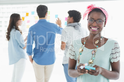 Young creative woman smiling at camera