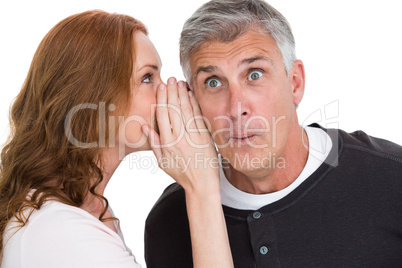 Woman telling secret to her partner