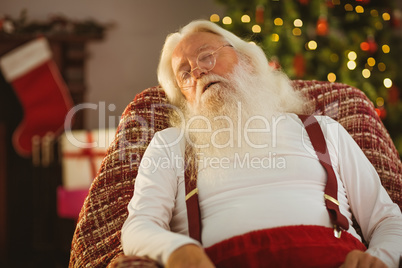 Santa claus sleeping on the armchair