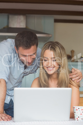 Cute couple using laptop together Cute couple using laptop together