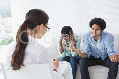 Angry couple talking to their therapist