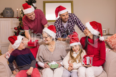 Happy family exchanging christmas gifts