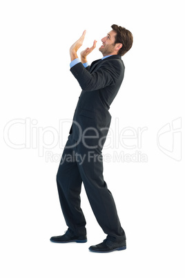 Focused businessman pushing with hands