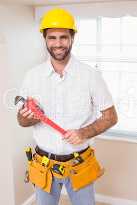 Handyman smiling at camera in tool belt