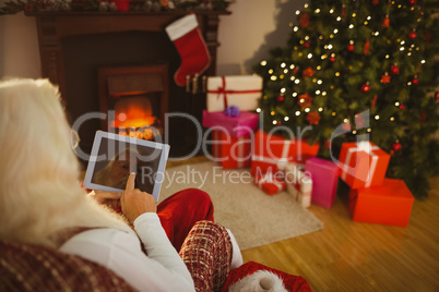 Santa claus touching digital tablet