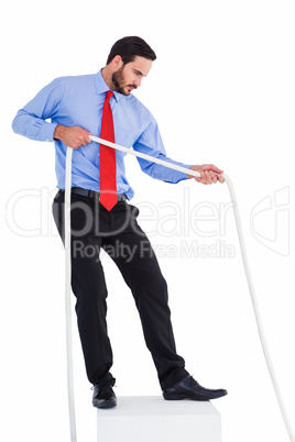 Focused businessman pulling a rope