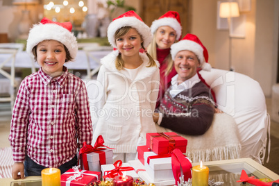 Portrait of a festive family in santa hat