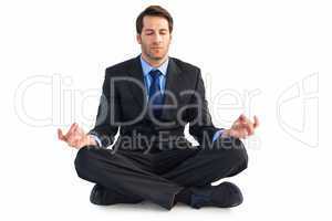 Calm businessman sitting in lotus pose