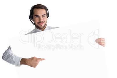 Businessman with headphone showing sign to camera