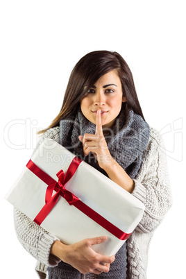 Brunette holding gift and keeping a secret Brunette holding gift and keeping a secret