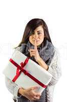 Brunette holding gift and keeping a secret