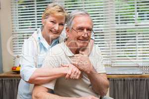 Senior couple smiling at the camera together