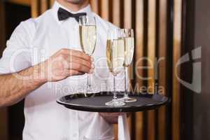 Waiter holding tray of champagne