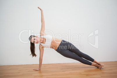 Fit brunette doing yoga at home