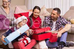 Happy family opening christmas gifts together