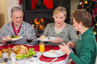 Smiling extended family at the christmas dinner table