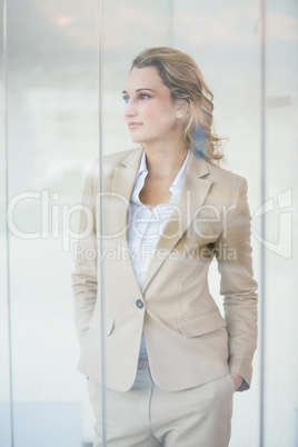 Portrait of thoughtful businesswoman through the window