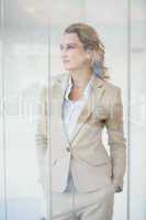 Portrait of thoughtful businesswoman through the window