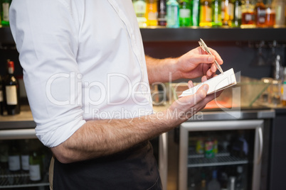 Waiter taking order in his notepad