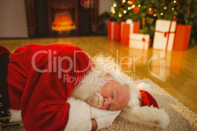 Father christmas sleeping on the rug