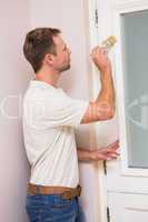 Painter painting the door white