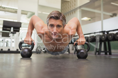 Fit man using kettlebells in his workout