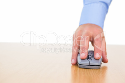 Hand of a businessman using mouse at desk