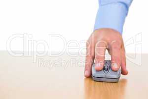 Hand of a businessman using mouse at desk