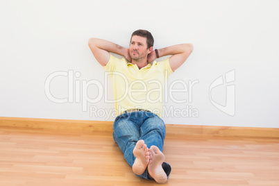 Casual man sitting on floor at home