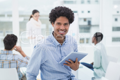 Casual businessman holding his tablet