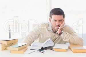 Bored casual businessman studying at his desk