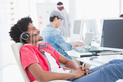 Young creative man listening to music