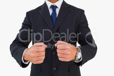 Businessman in suit clenching fists