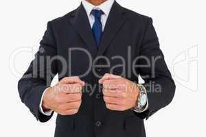 Businessman in suit clenching fists