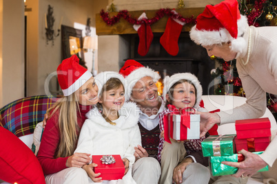 Grandmother giving several gifts to her family