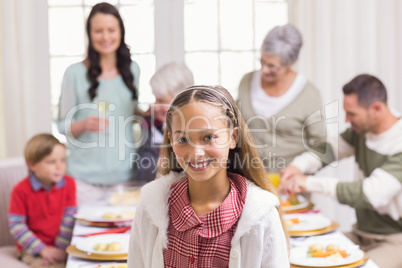 Portrait of girl smiling at camera in front of her family