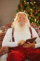Happy santa using digital tablet