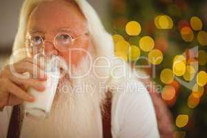 Father christmas drinking glass of milk
