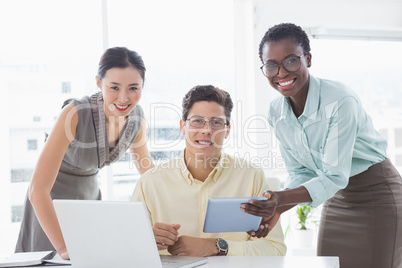 Casual business team looking at tablet together