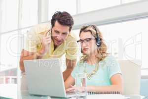 Pretty designer with headphone working on computer