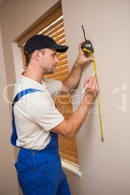 Construction worker using measuring tape