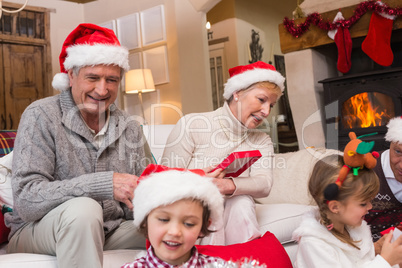 Happy family opening christmas gifts together