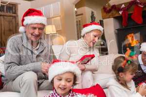 Happy family opening christmas gifts together