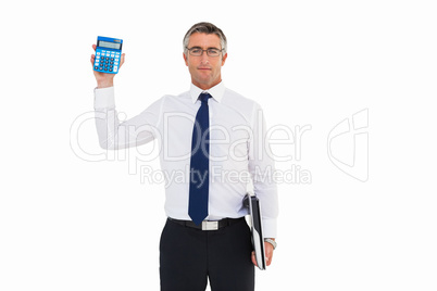 Businessman showing calculator while holding his laptop